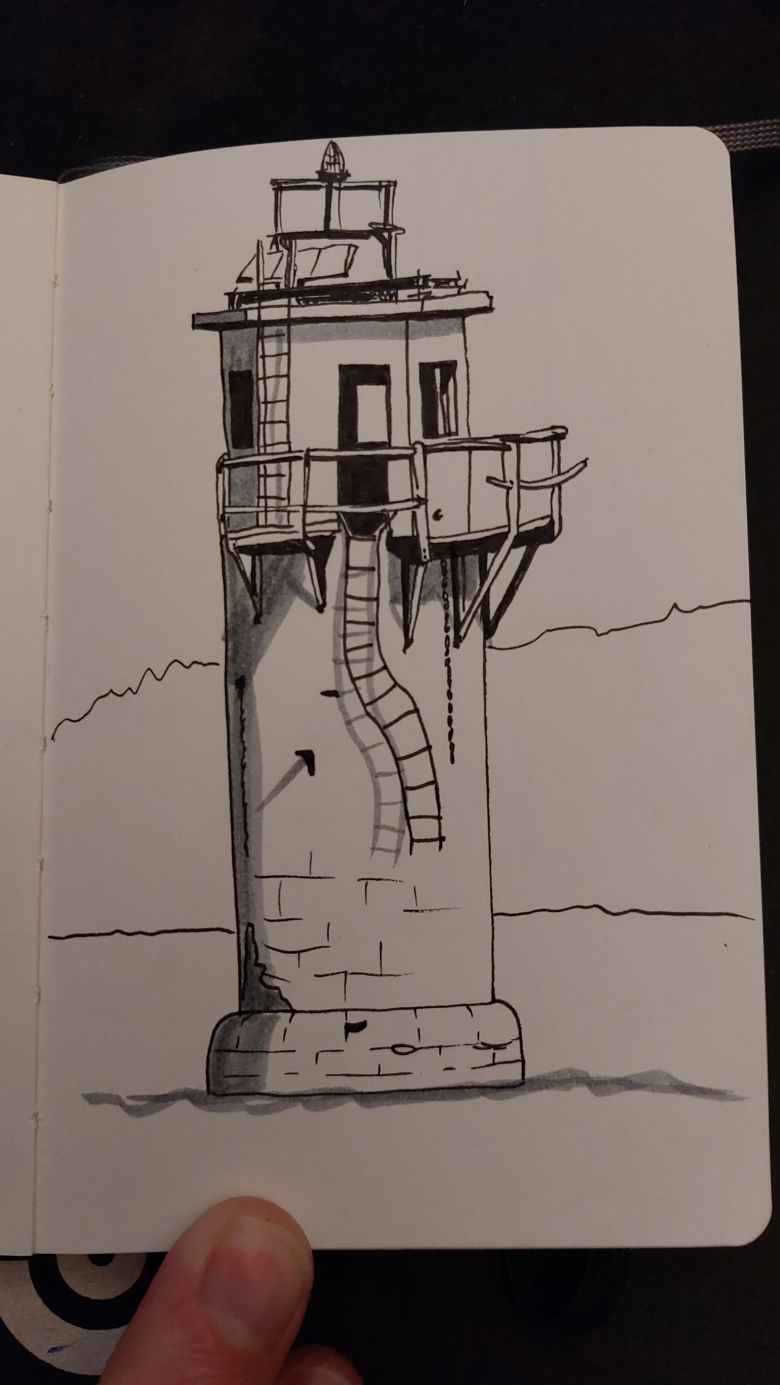 Another lighthouse. This one quite small, the type you might find near a harbour. There is a walkway around the outside with a ladder coming down from it. Both are twisted and partly missing.