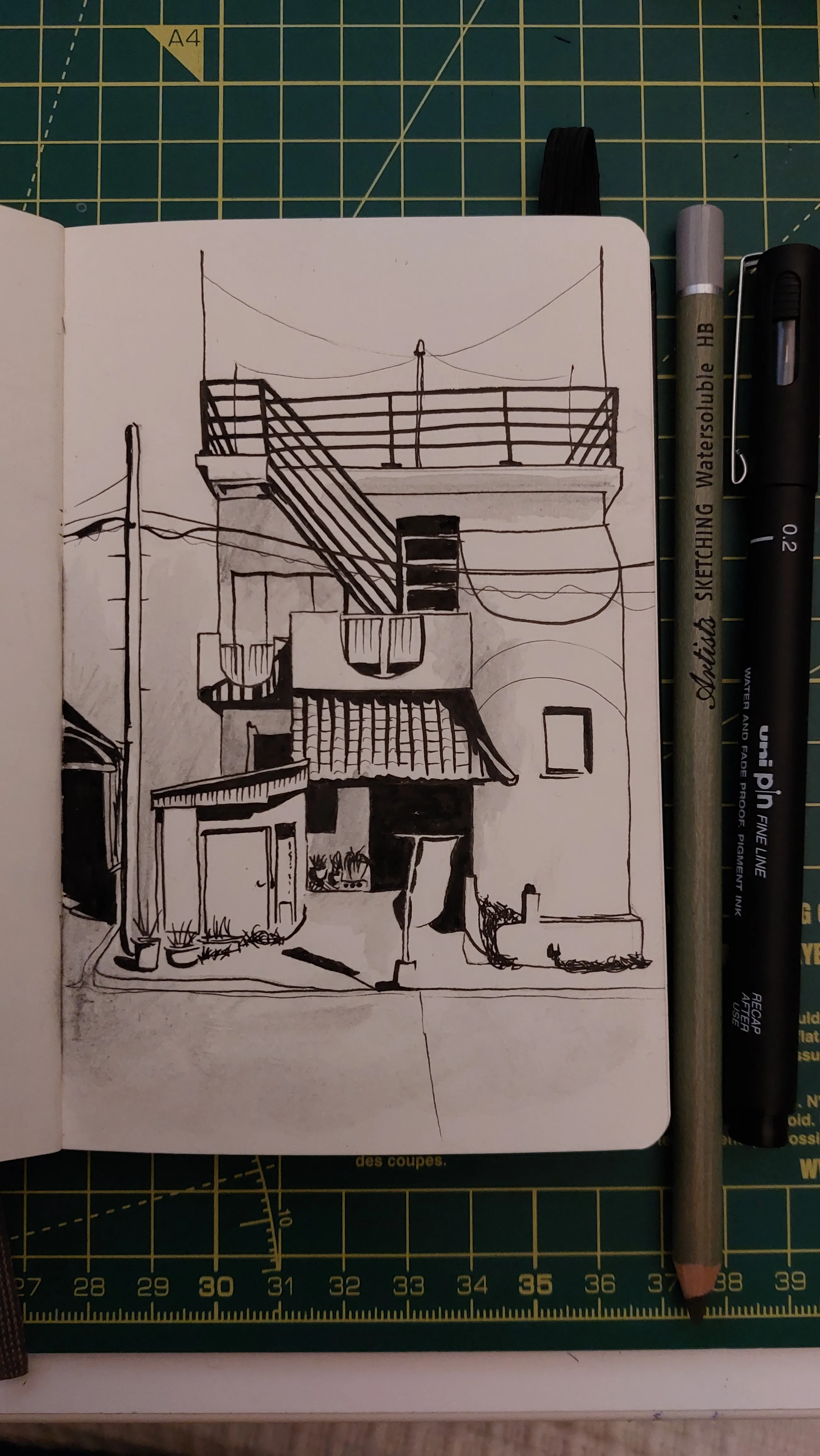 A line drawing of in black pen of a small Japanese building. There's a small shed type structure in front.