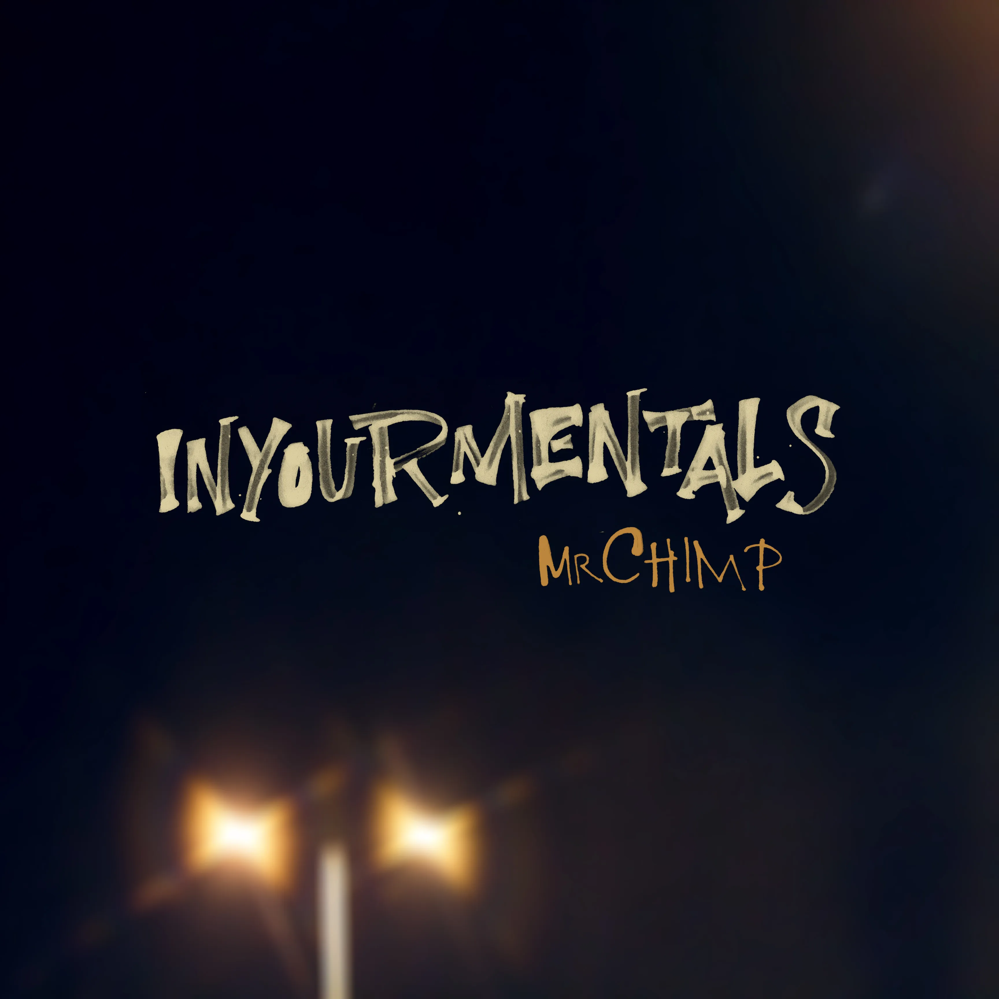 A dark image that if you squint you make out is a blurry photo of a streetlight. Over the top in rough handwritten lettering it says "Inyourmentals" and then in smaller text "Mr Chimp"