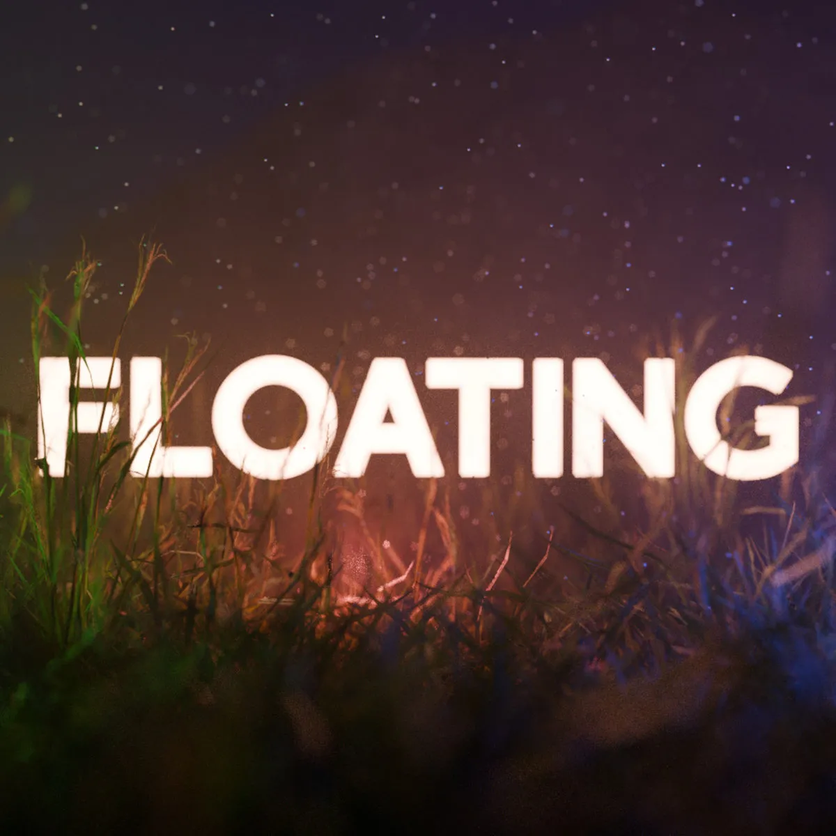 A square image. In the center is the word "Floating" in large, bold, glowing white, sans-serif letters. The word is floating amidst some long grass which is lit by green, red and blue lights. Motes of dust float in the air.